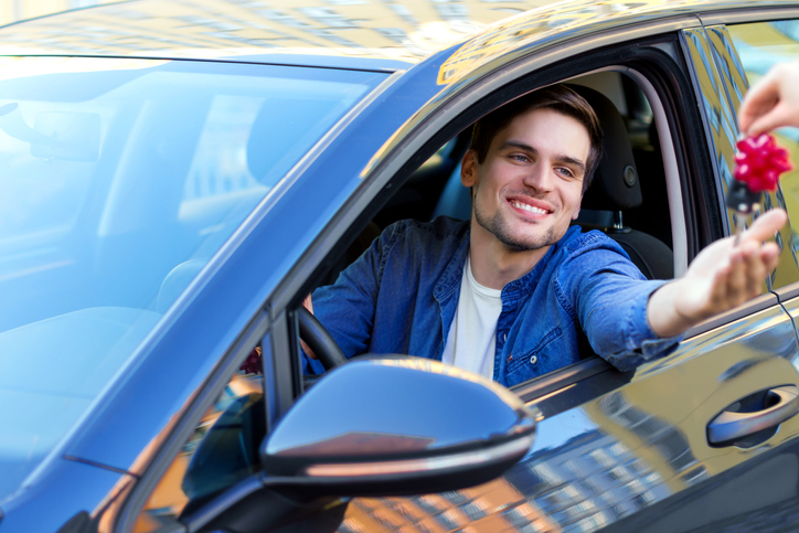 Happy buisnessman bought a new car as gift