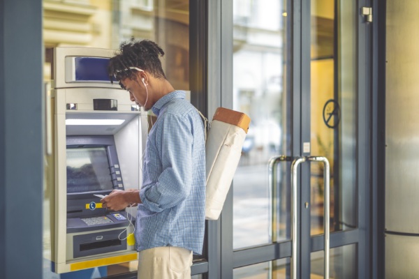 Man standing in front of ATM