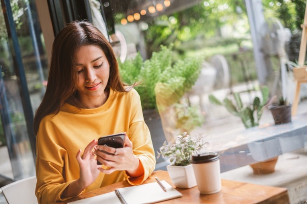 Lady sitting with cellphone in hand